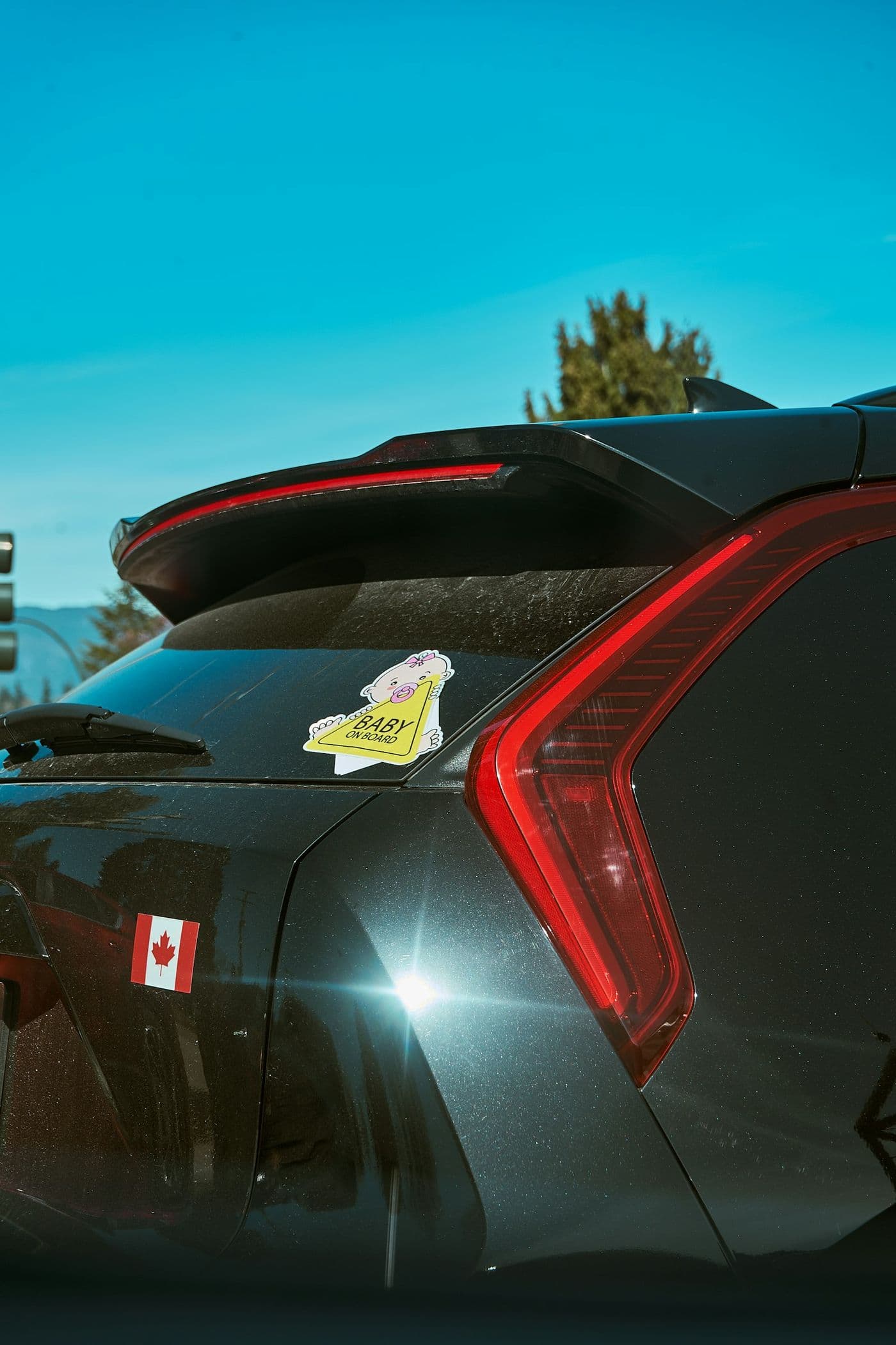 Stickers on a car rear window and painted tailgate panel
