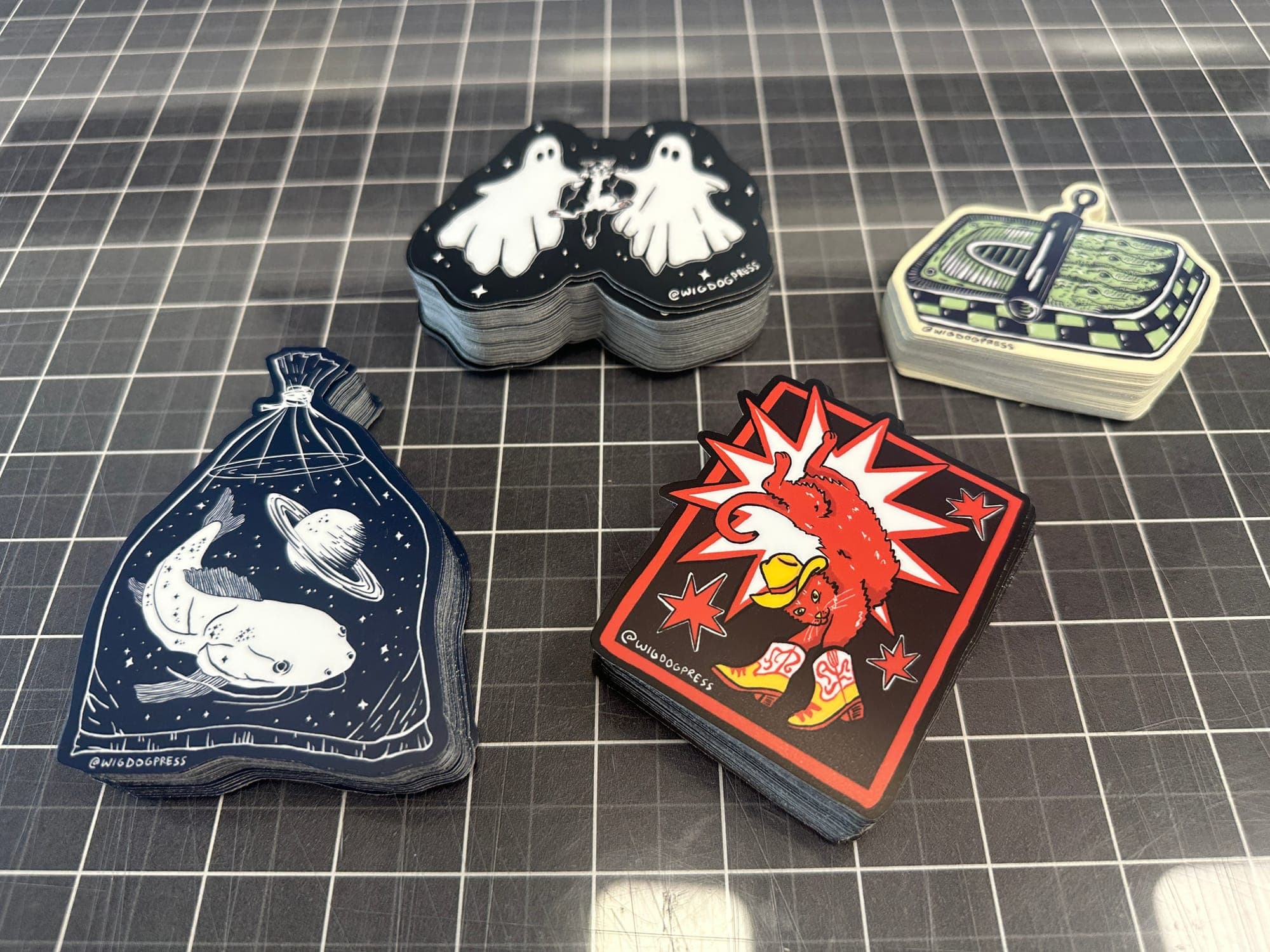Stack of colorful die cut vinyl stickers, small and meant to be handed out