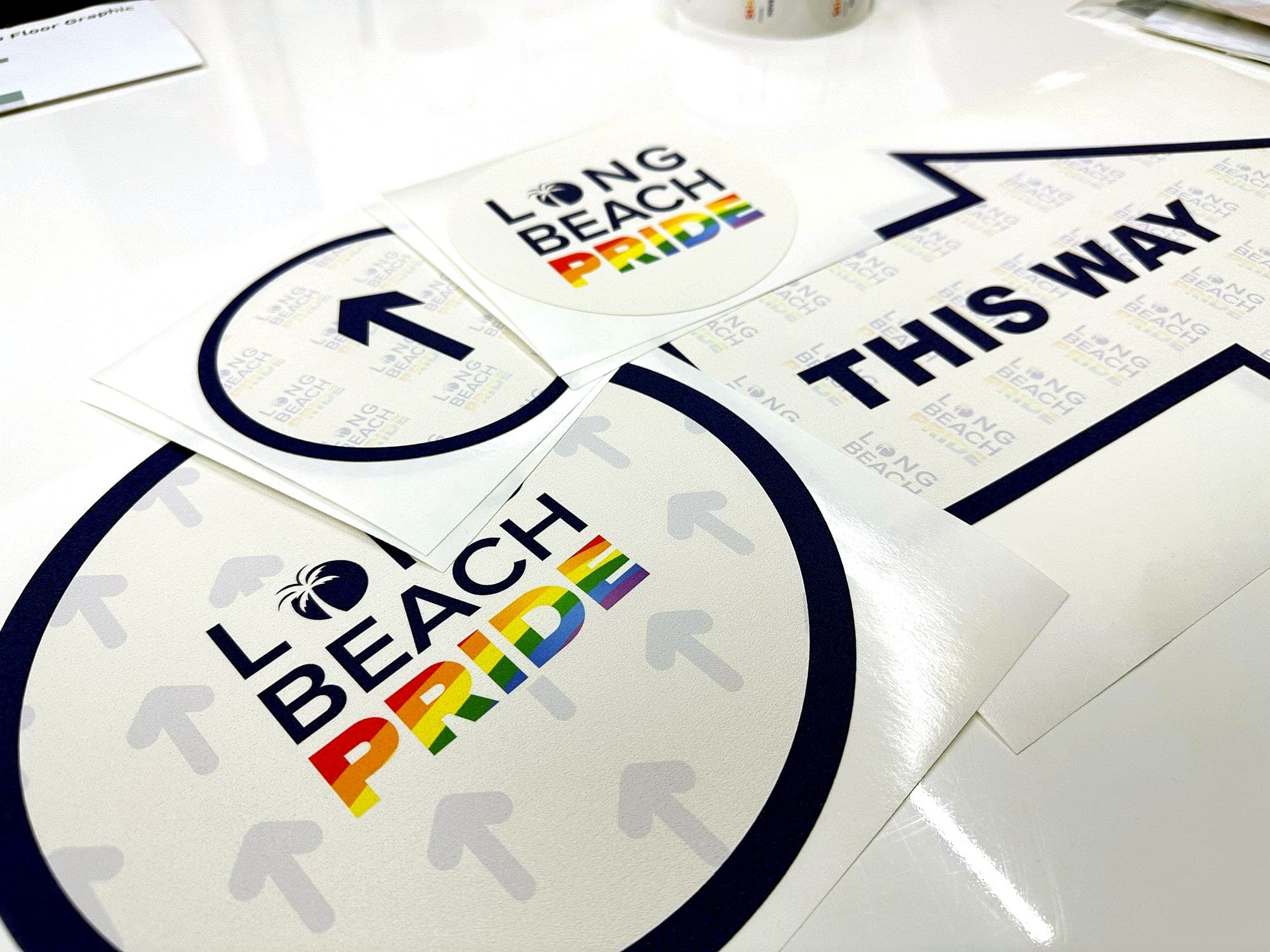 Long Beach Pride die cut stickers and 'This Way' floor graphics