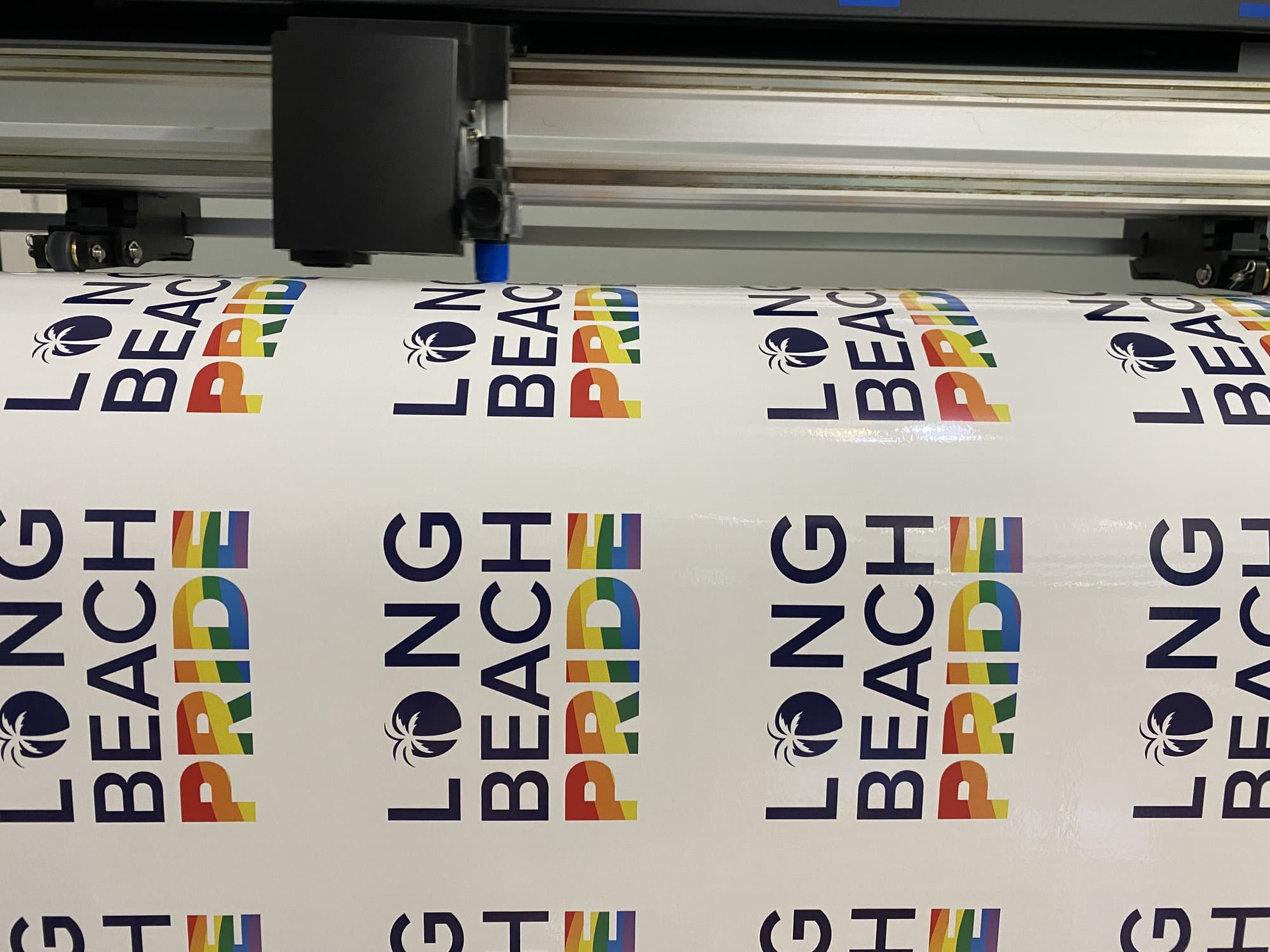 Long Beach Pride stickers printed on a roll at the cutter