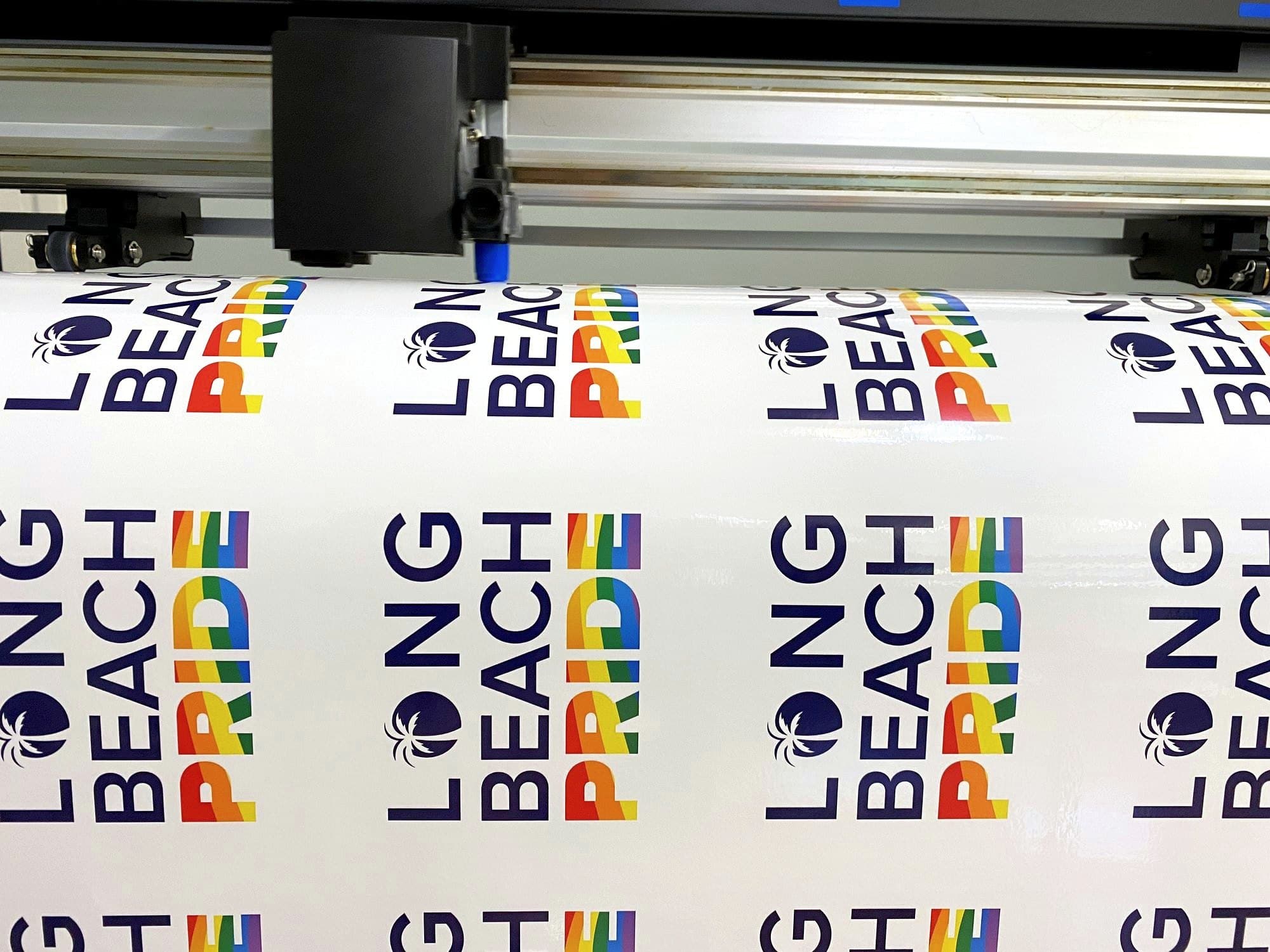 Long Beach Pride stickers printed on a roll at the cutter