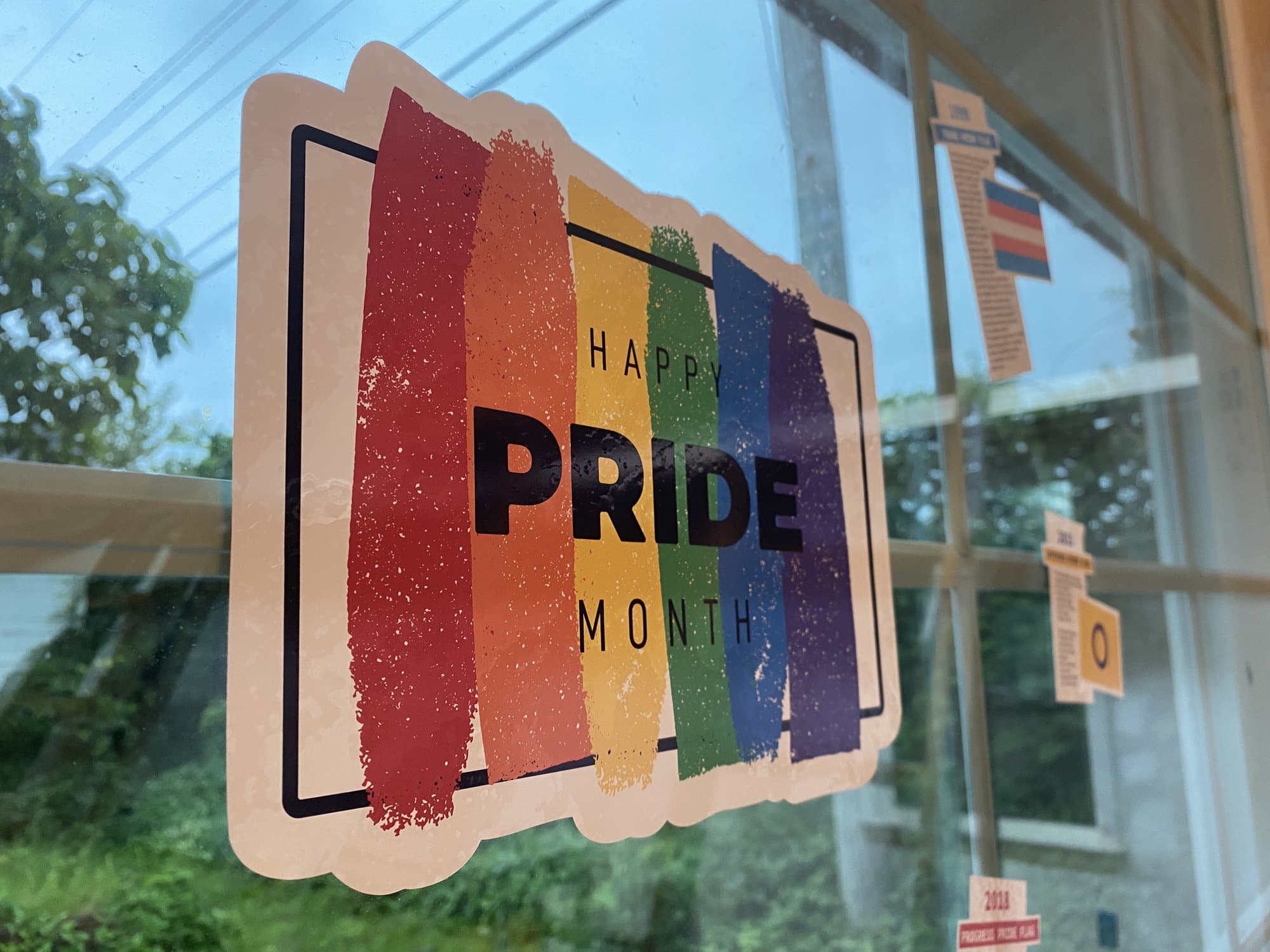 The Happy Pride Month static cling centerpiece on the store window
