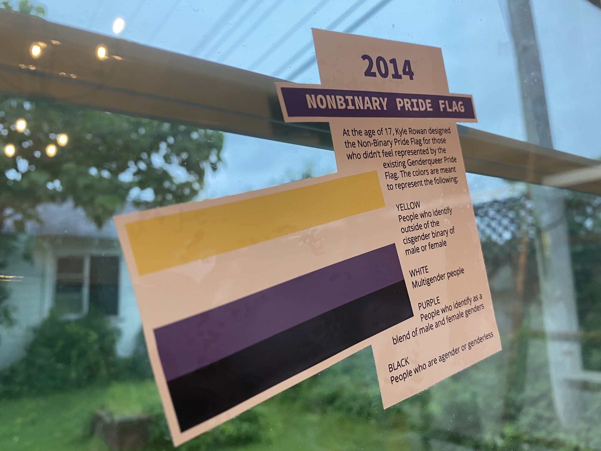 A 2014 Nonbinary Pride Flag history cling explaining each stripe